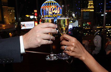 Two champagne glasses clinking after a marriage proposal in Vegas