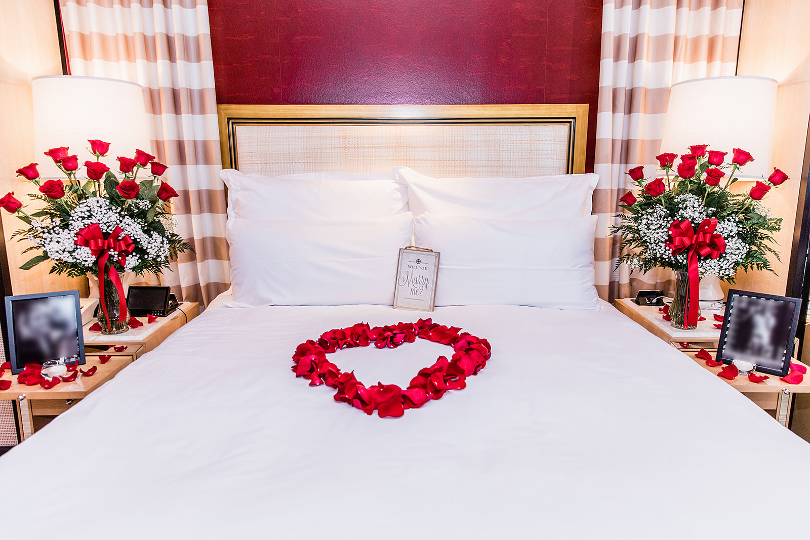 Wedding proposal decorations with roses on bed