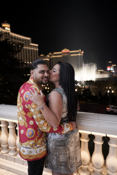 Couple posing for Surprise Photographer Proposal Tour in Las Vegas near Bellagio fountains