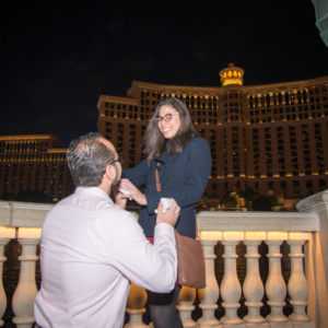 Man proposes to woman in front of Bellagio Fountains in Las Vegas with proposal photographer