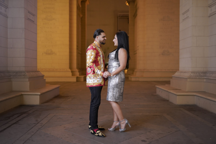 A couple pauses for engagement photos while on a proposal photo tour in Las Vegas