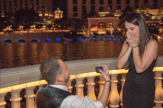 Man proposes to woman in front of Bellagio fountains on the Las Vegas strip