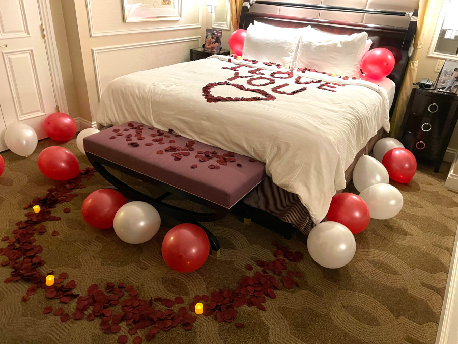 Las Vegas hotel room decorated with balloons, roses and candles for an anniversary
