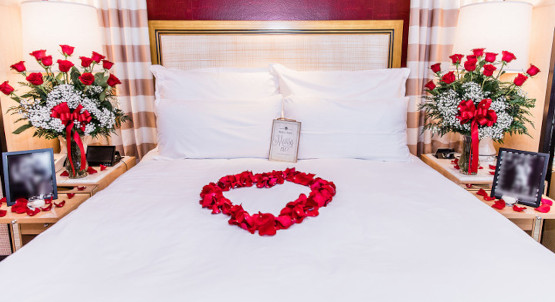 Hotel room bed in Las Vegas with romantic decorations, roses and rose petals