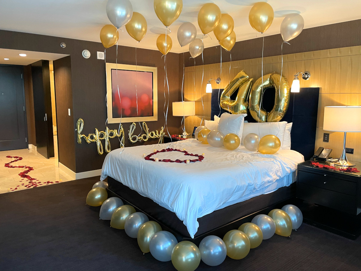 Las Vegas hotel room decorated with balloons, roses and candles for a birthday