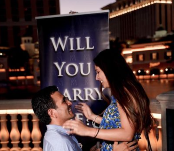 Man and woman celebrate their marriage proposal after a magic show on the Las Vegas strip at Bellagio fountains