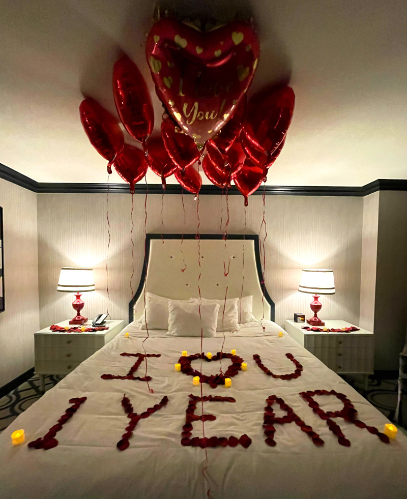 Las Vegas hotel room decorated with balloons, roses and romantic decorations for an anniversary