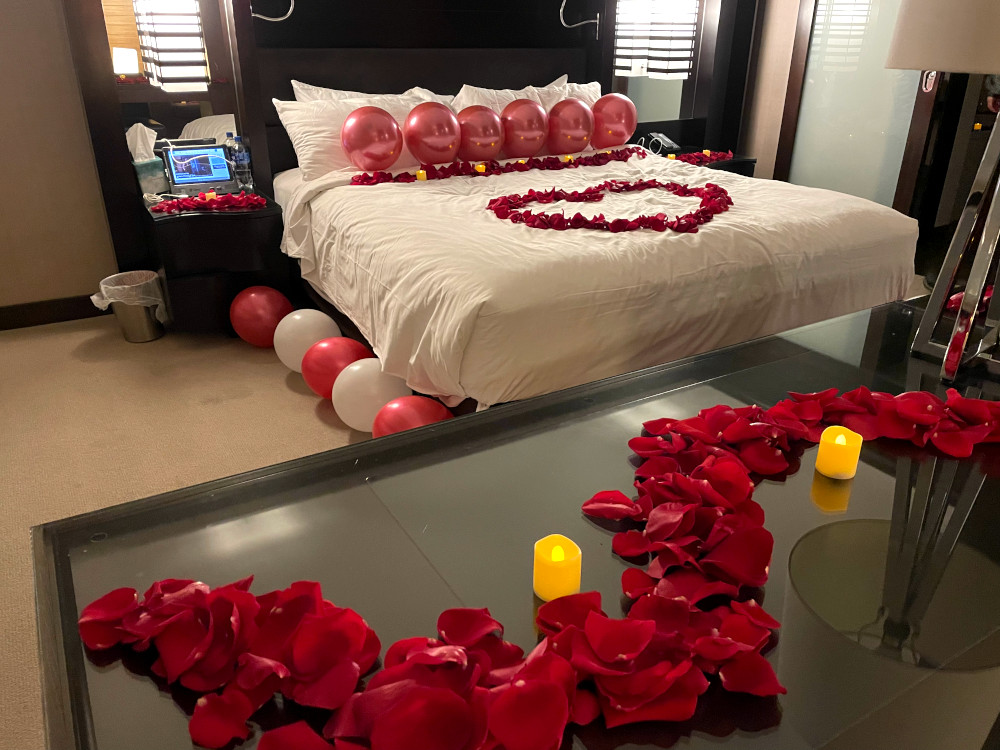 Las Vegas hotel room decorated with balloons, roses and romantic decorations for a marriage proposal