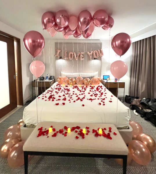 A room at a hotel in Las Vegas is decorated for a romantic celebration on Valentines Day. Balloons, rose petals, candles, and an "I love you" banner are set up on and around the bed
